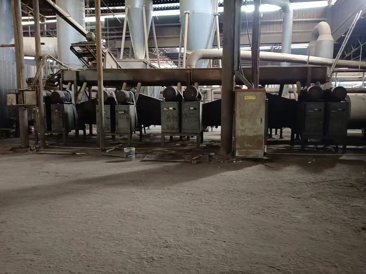 Forming workshop with a row of extrusion machines, control cabinets and overhead conveyors